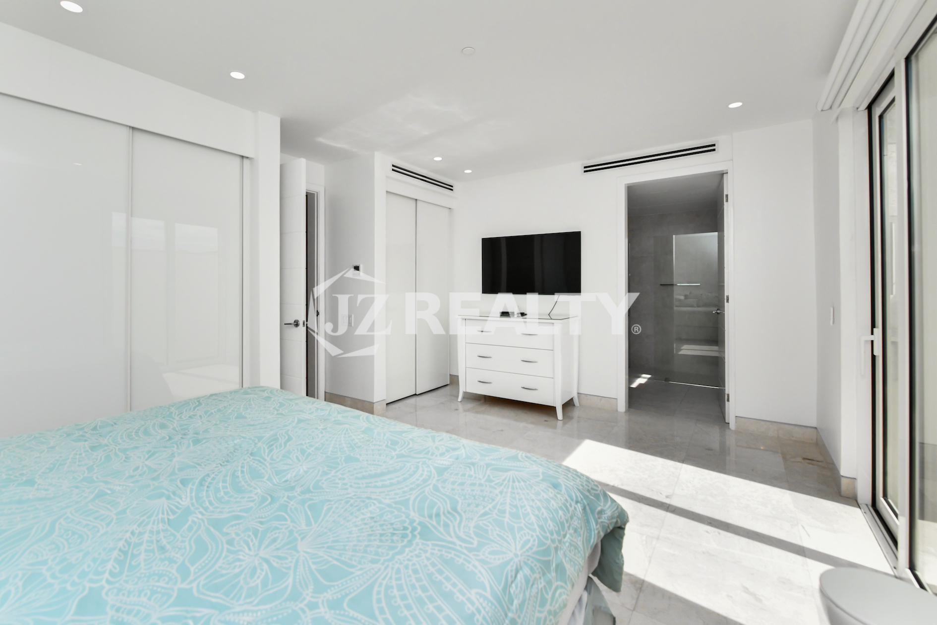 Spacious open-plan living space with high ceilings and premium finishes at Coral Shell Condo GF-C, Oranjestad, Aruba.