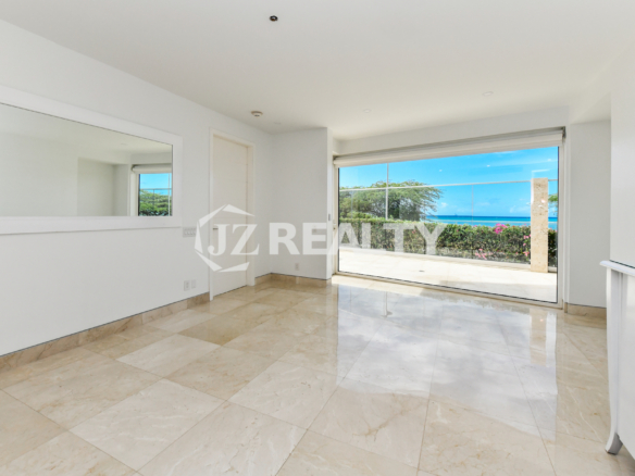 Spacious bedroom with an ocean view at Coral Shell Condo GF-C in Oranjestad, Aruba.