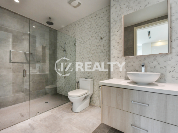 Modern luxury bathroom at Coral Shell Condo GF-C, featuring a sleek glass-enclosed shower and elegant vanity.