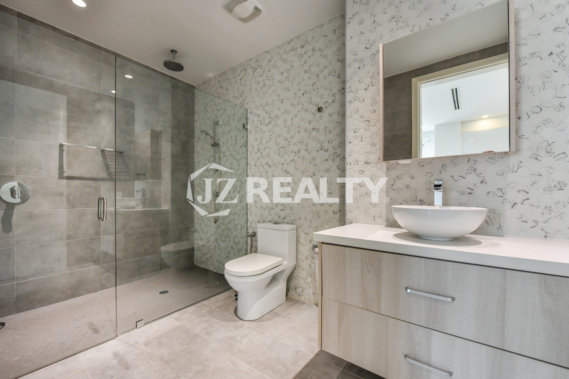 Modern luxury bathroom at Coral Shell Condo GF-C, featuring a sleek glass-enclosed shower and elegant vanity.