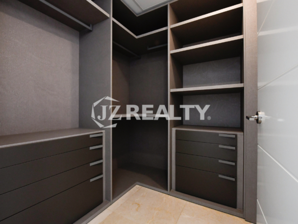 Luxury walk-in closet with custom storage solutions at Coral Shell Condo GF-C.