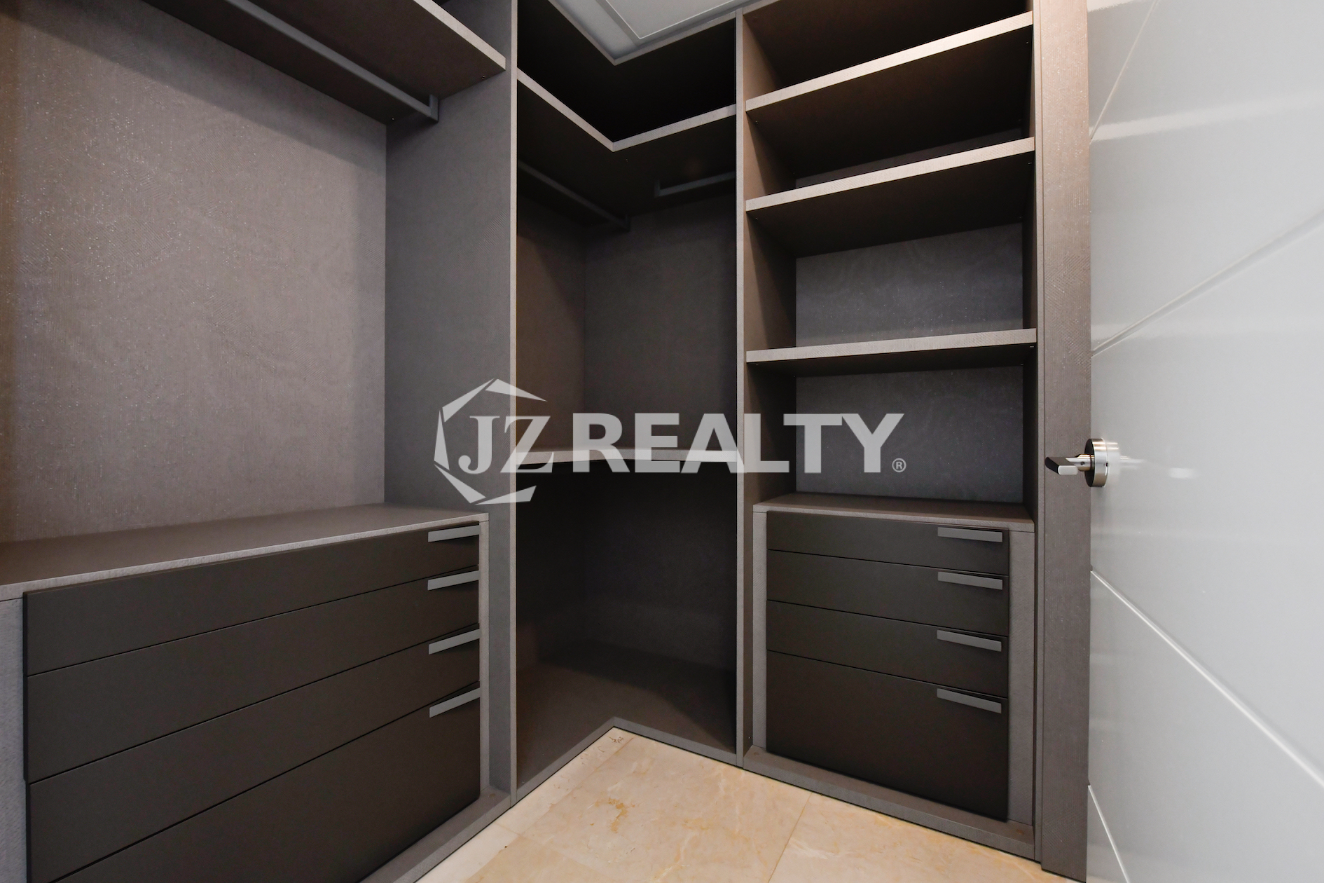 Luxury walk-in closet with custom storage solutions at Coral Shell Condo GF-C.