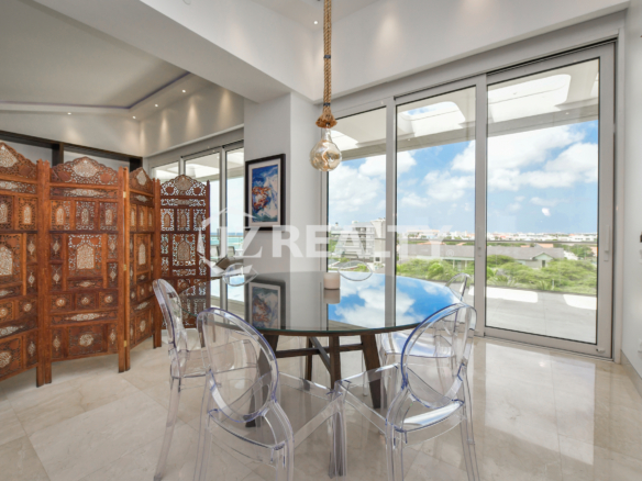 Luxurious bedroom with a private balcony and scenic views at Coral Shell Penthouse B.