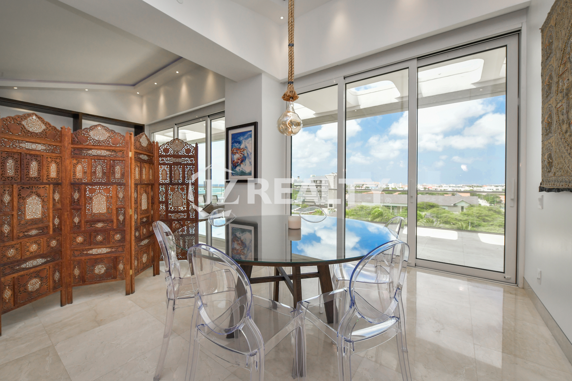 Luxurious bedroom with a private balcony and scenic views at Coral Shell Penthouse B.