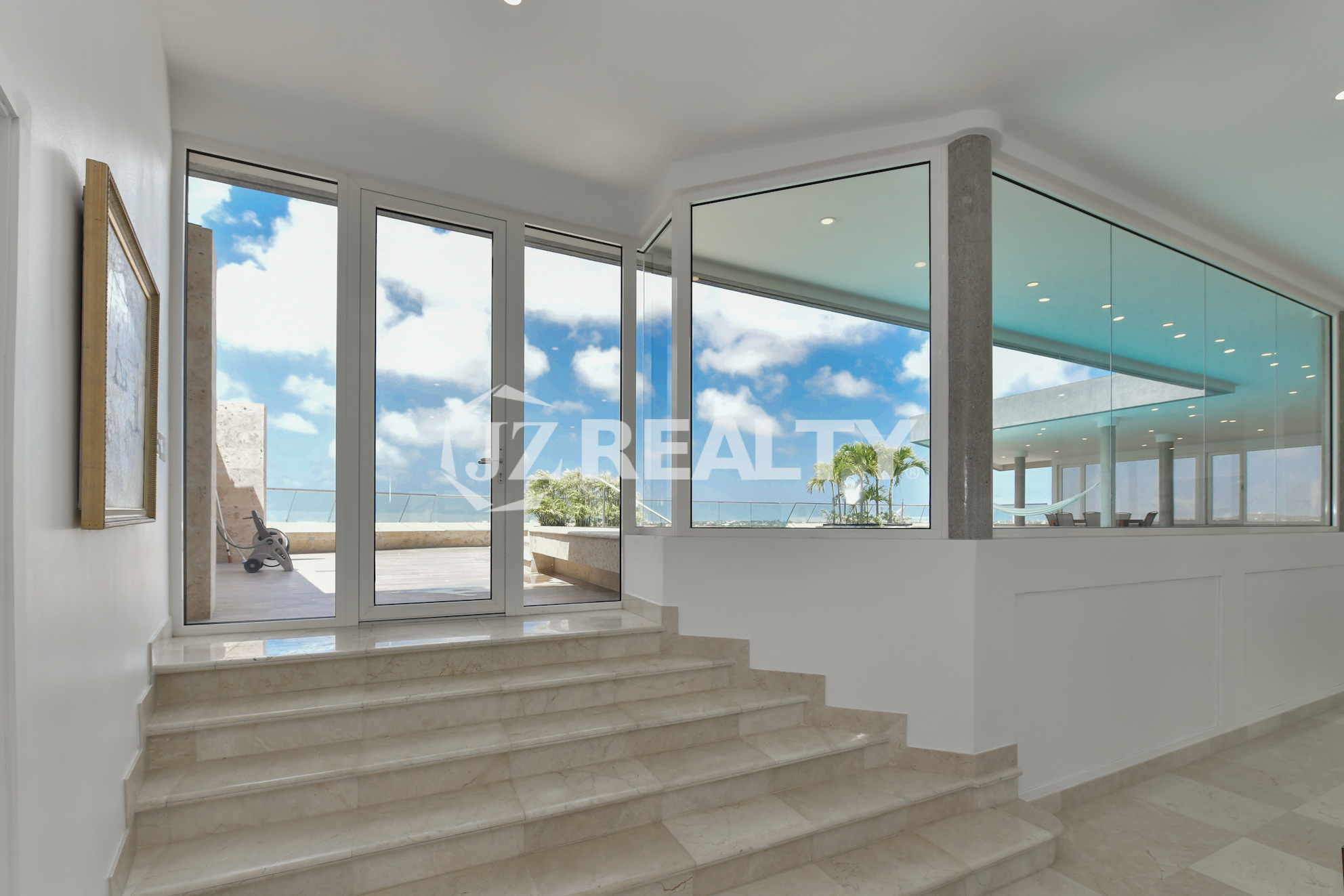Stylish dining area at Coral Shell Penthouse B with panoramic ocean views and elegant decor.