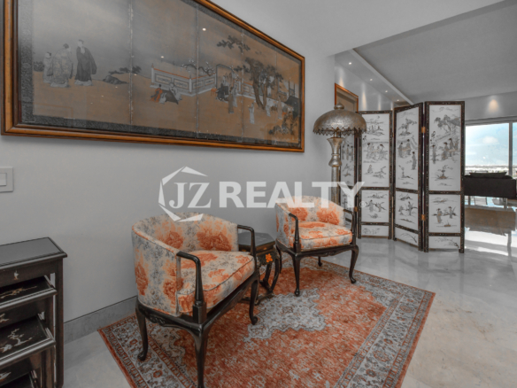 Spacious and elegantly furnished lounge area with ocean views at Coral Shell Penthouse B.