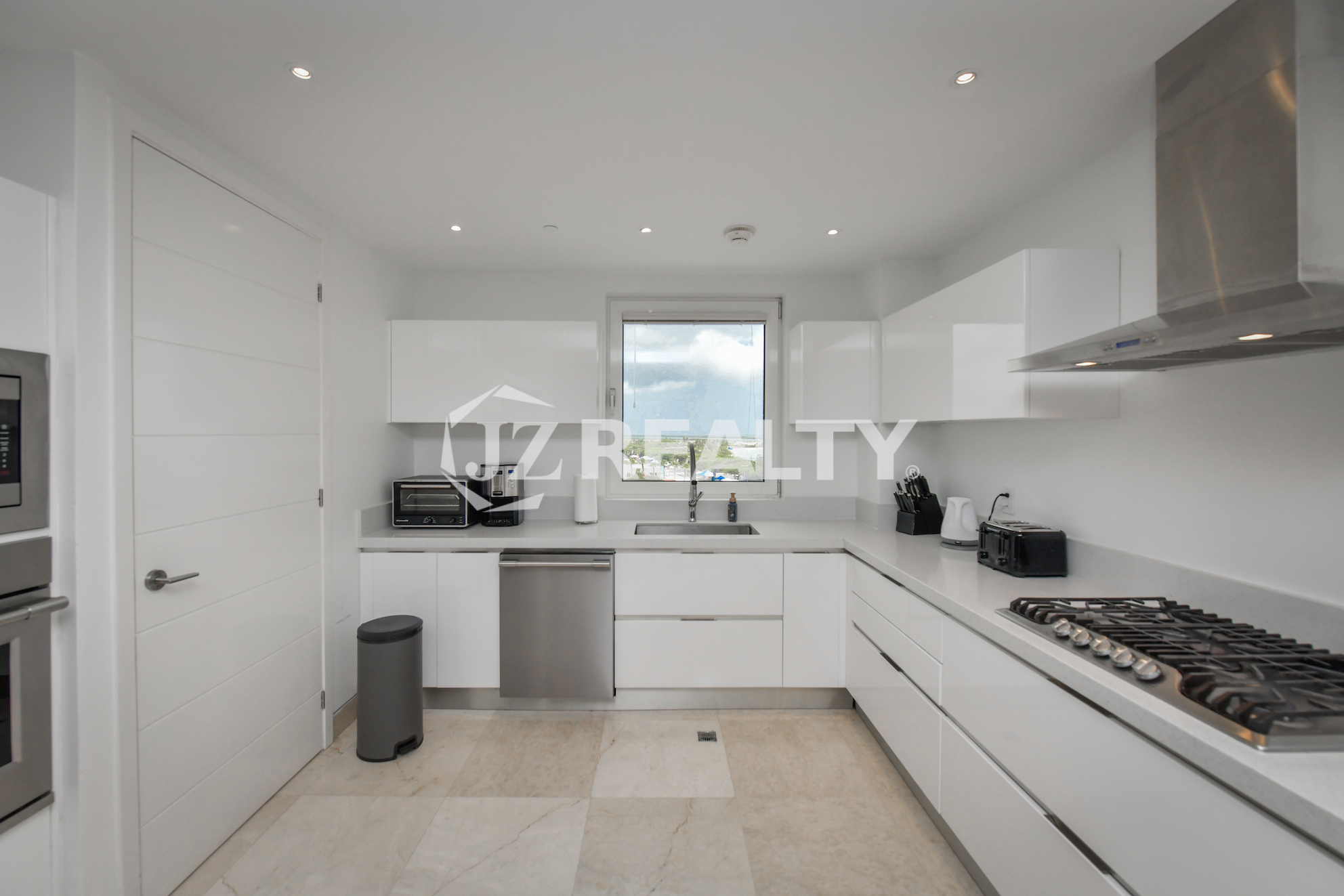 Stylish grand entrance with glass doors leading to the rooftop terrace at Coral Shell Penthouse B.