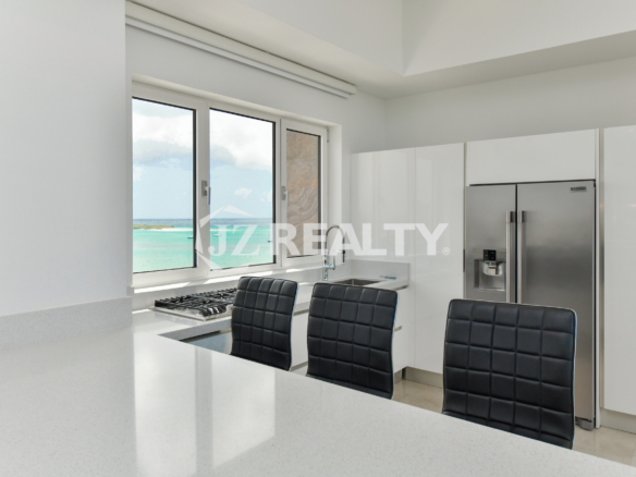 Private home theater with luxury red leather seating at Coral Shell Penthouse B.