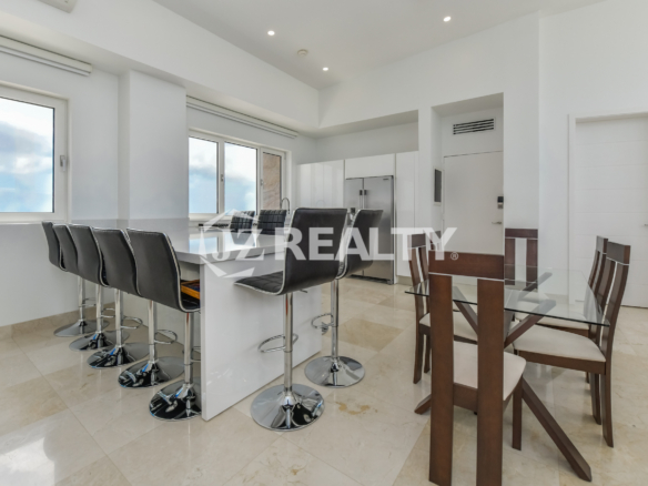Luxurious kitchen with ocean view at Coral Shell Penthouse B, featuring modern appliances and elegant white design.