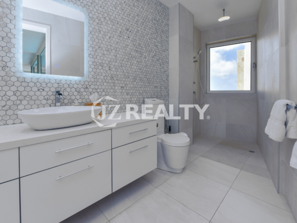 Elegant master bathroom at Coral Shell Penthouse B, featuring modern finishes, a spa-like ambiance, and ocean views.