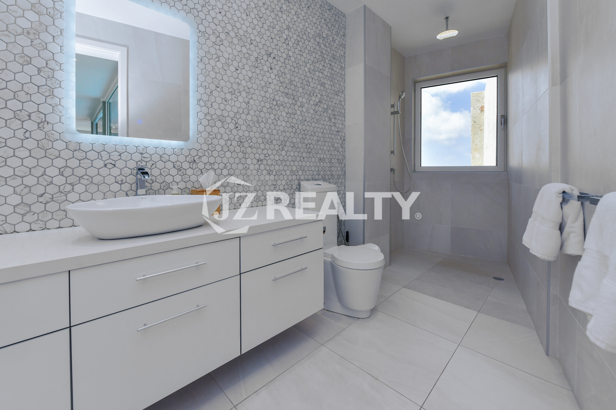 Elegant master bathroom at Coral Shell Penthouse B, featuring modern finishes, a spa-like ambiance, and ocean views.