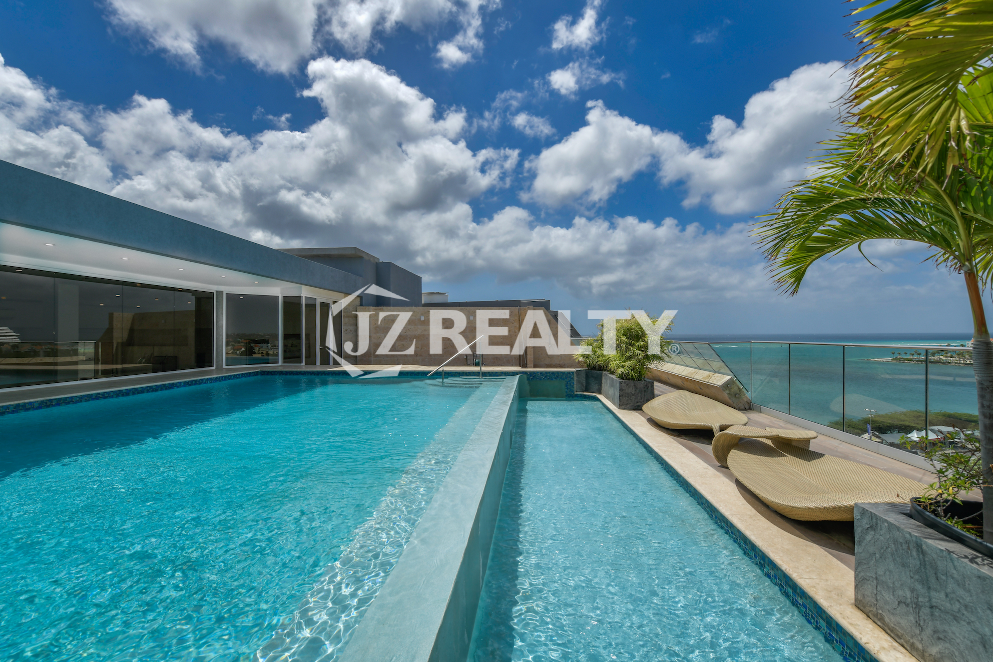 Oceanfront infinity pool at Coral Shell Penthouse B, featuring panoramic views and an exclusive poolside retreat.
