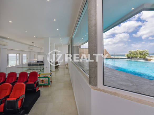 Rooftop pool lounge area with comfortable seating and panoramic ocean views at Coral Shell Penthouse B.