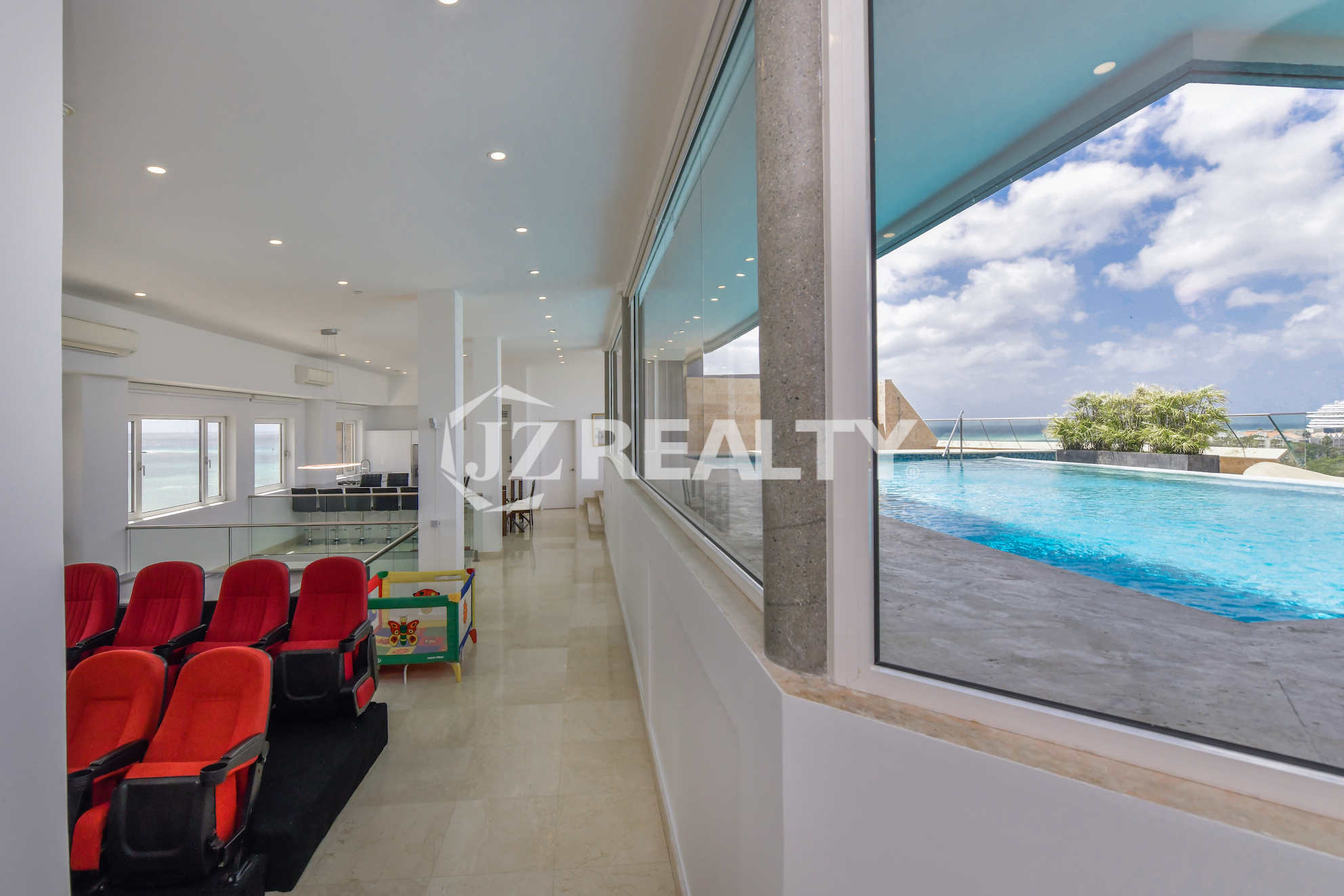 Rooftop pool lounge area with comfortable seating and panoramic ocean views at Coral Shell Penthouse B.