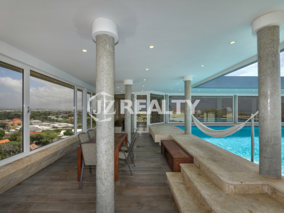 Relax in a rooftop hammock at Coral Shell Penthouse B, surrounded by breathtaking ocean and island views.