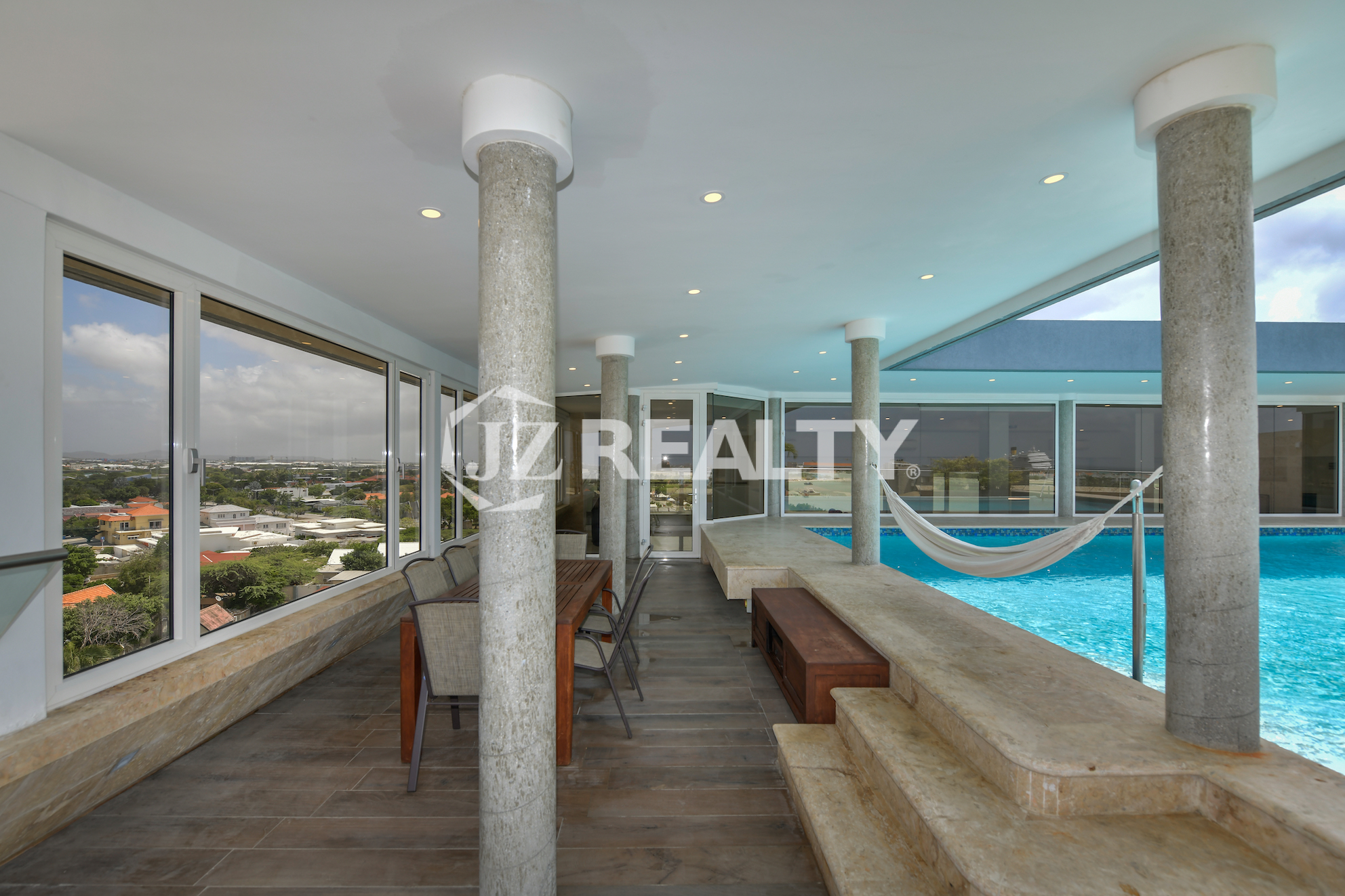 Relax in a rooftop hammock at Coral Shell Penthouse B, surrounded by breathtaking ocean and island views.