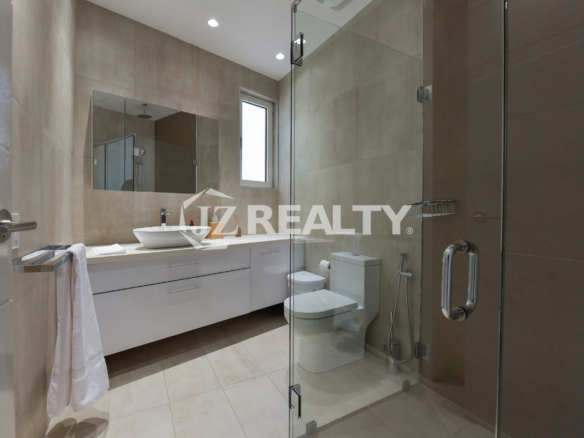Elegant modern bathroom with glass shower and luxury finishes at Coral Shell Penthouse B.