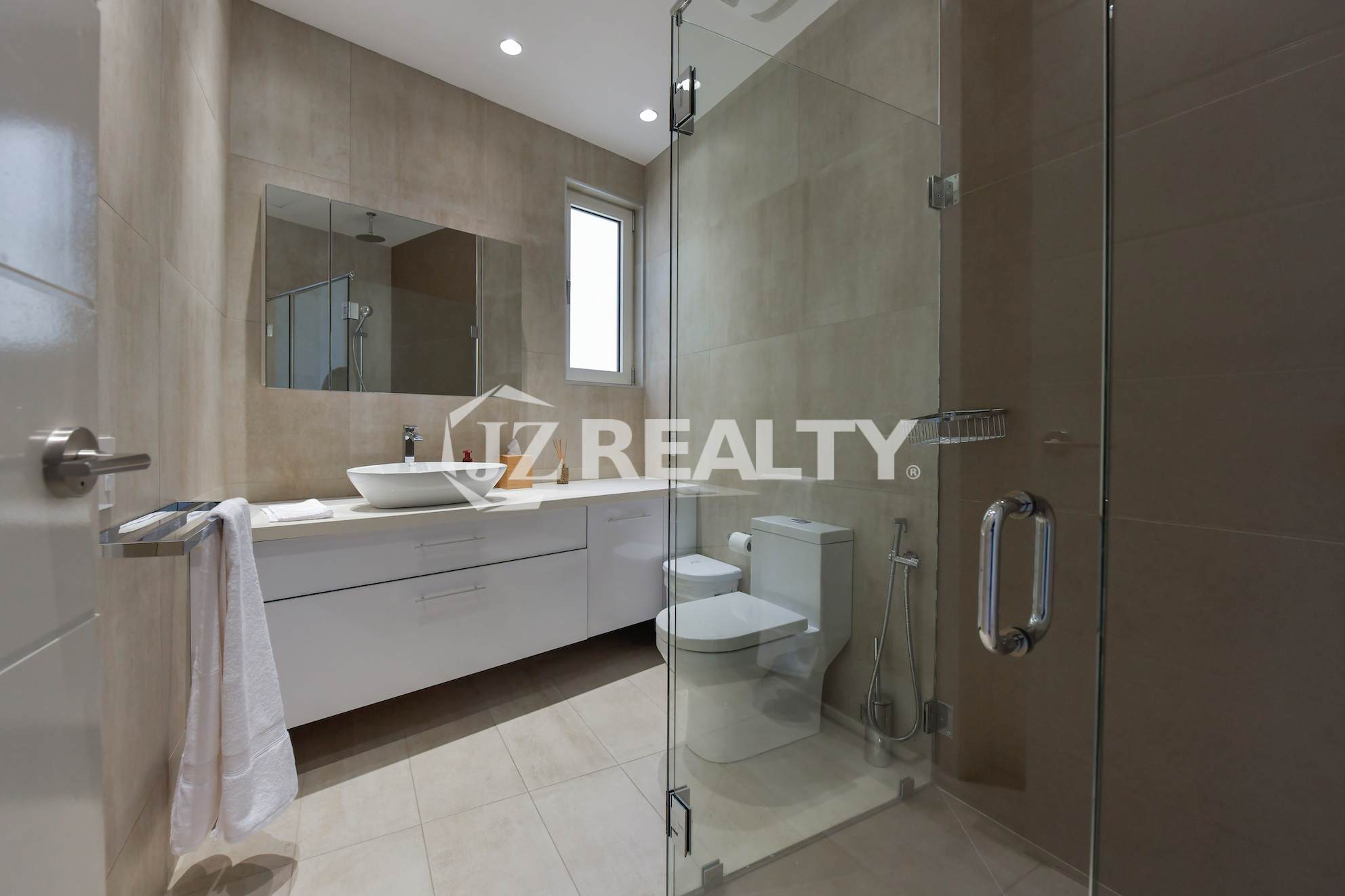 Elegant modern bathroom with glass shower and luxury finishes at Coral Shell Penthouse B.