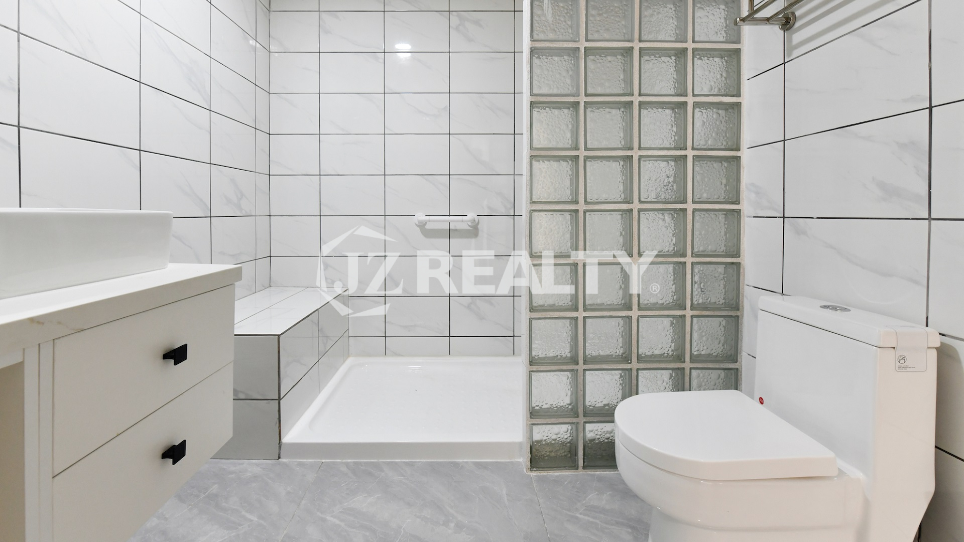 condo 211 bathroom with tub shower combination and glass blocks