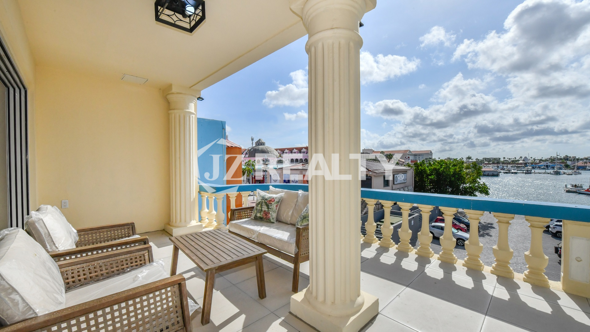 condo 211 balcony with wicker seating and marina views