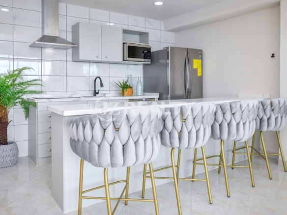 condo 213 kitchen island with designer tufted bar stools