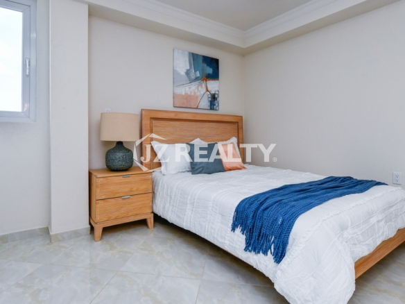 condo 213 master room with wooden furniture and natural light