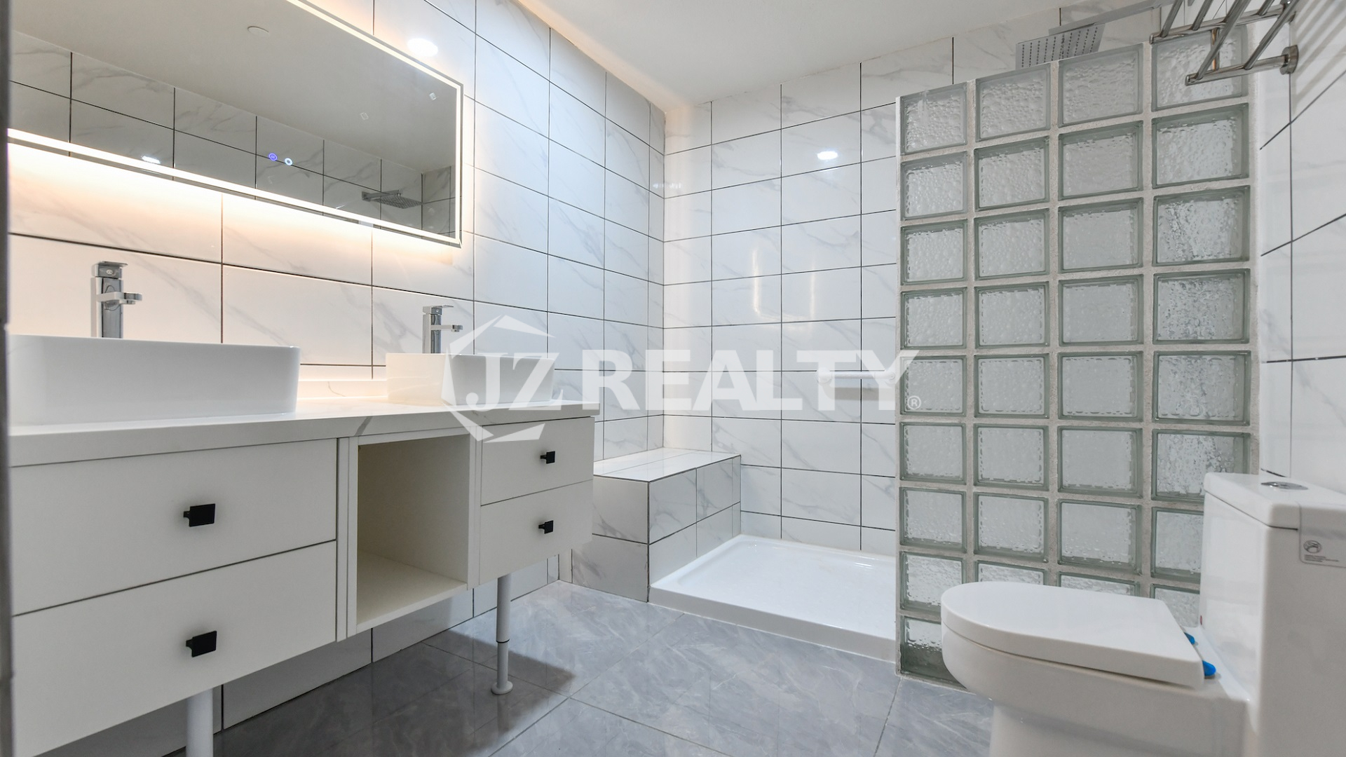 condo 216 featuring white tiles and glass block shower