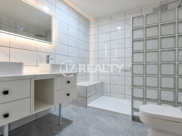 condo 312 featuring white tiles and glass block shower