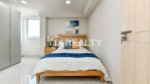 condo 313 master room with wooden furniture and window