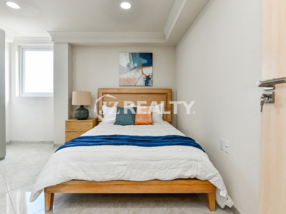 condo 313 master room with wooden furniture and window