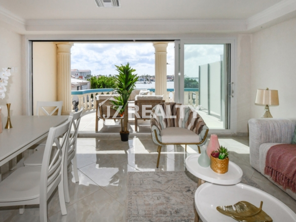 condo 317 living and dining area with harbor balcony views