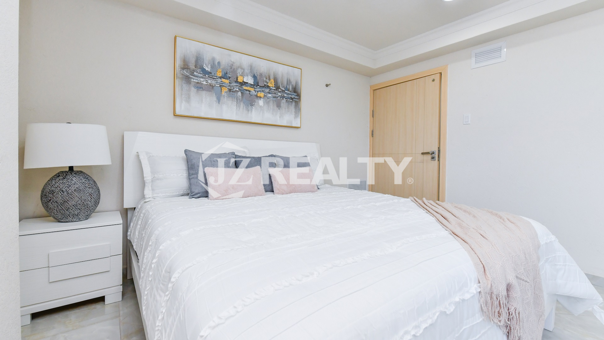 condo 317 second bedroom featuring white nightstand and decorative lamp