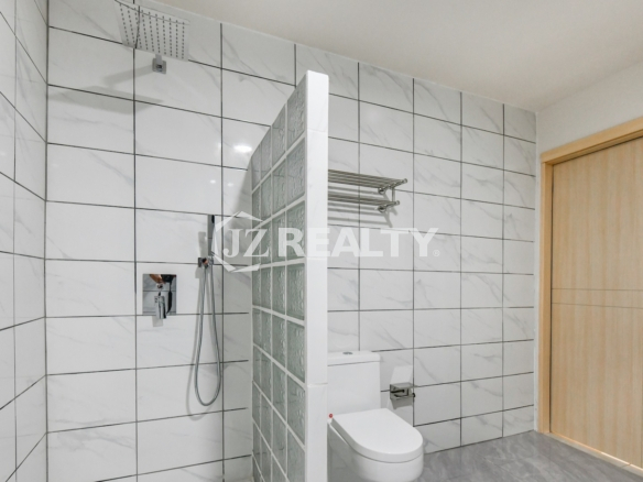 condo 315 Luxury bathroom with walk-in shower featuring glass block wall