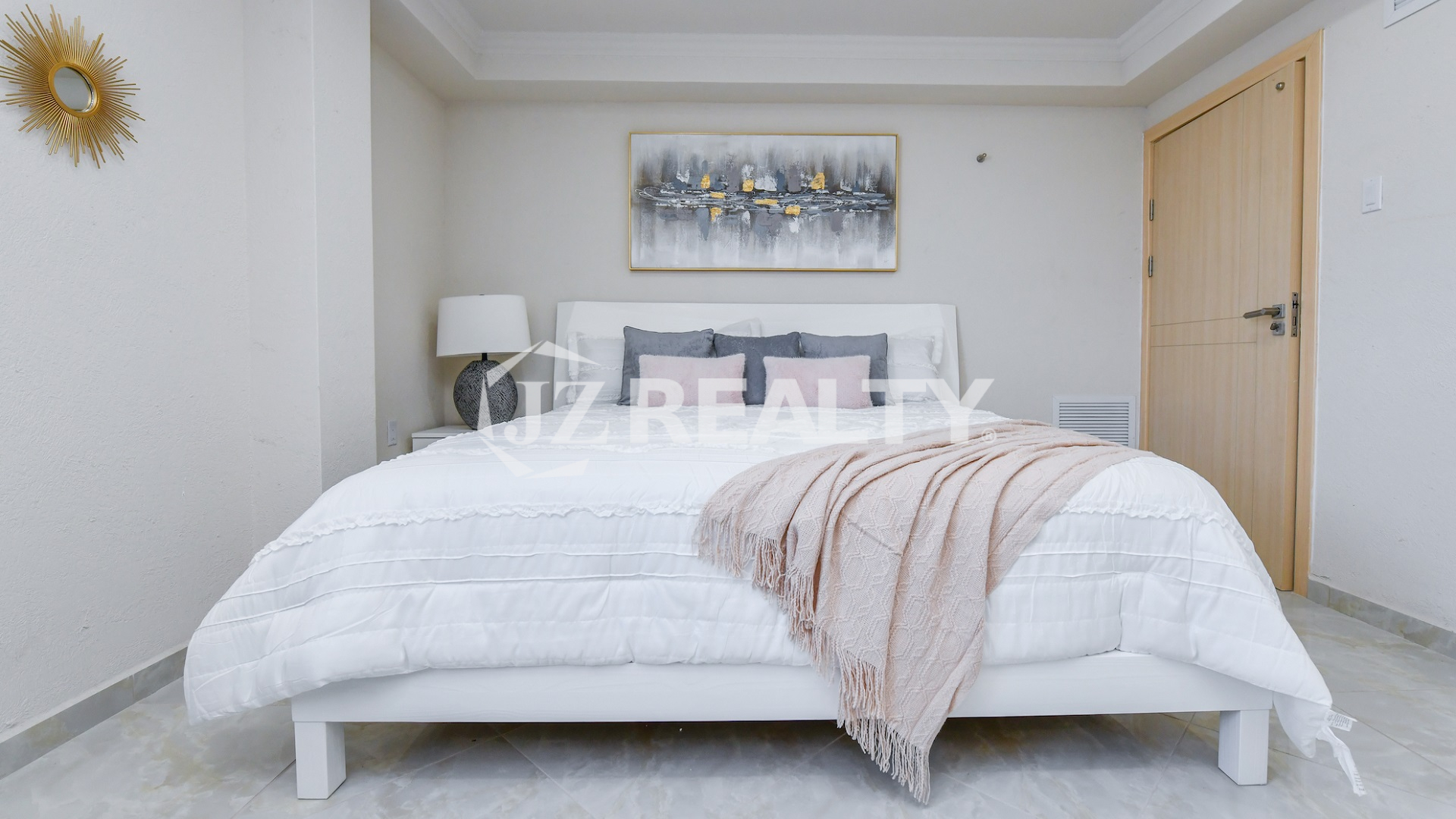 condo 318 second bedroom with white platform bed and artwork
