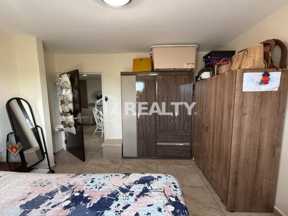 Bedroom with wardrobe closets and open doorway.