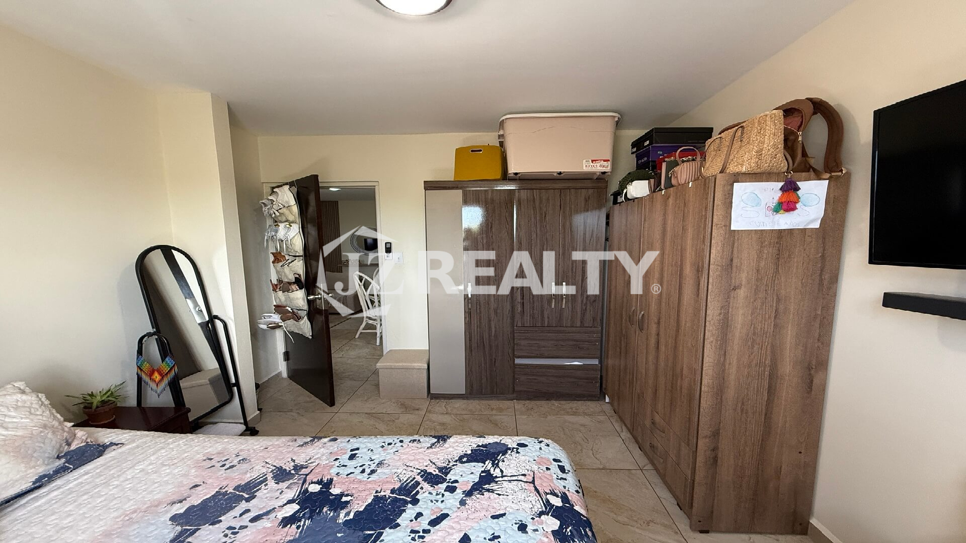 Bedroom with wardrobe closets and open doorway.