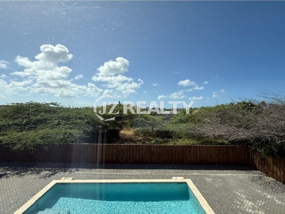 View of swimming pool and surrounding nature from Alto Vista 26-W Apartment 8 window.