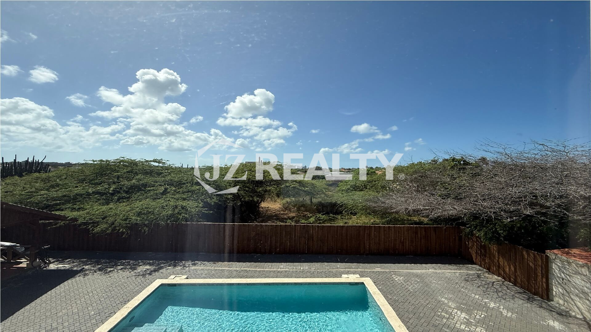 View of swimming pool and surrounding nature from Alto Vista 26-W Apartment 8 window.
