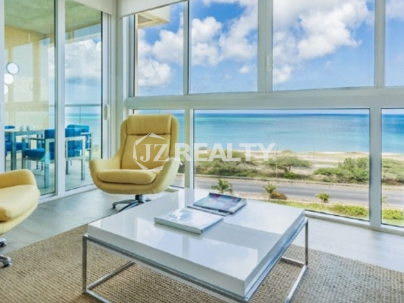 Condo 2-Bedroom Unit Blue Aruba living room with glass walls and ocean view