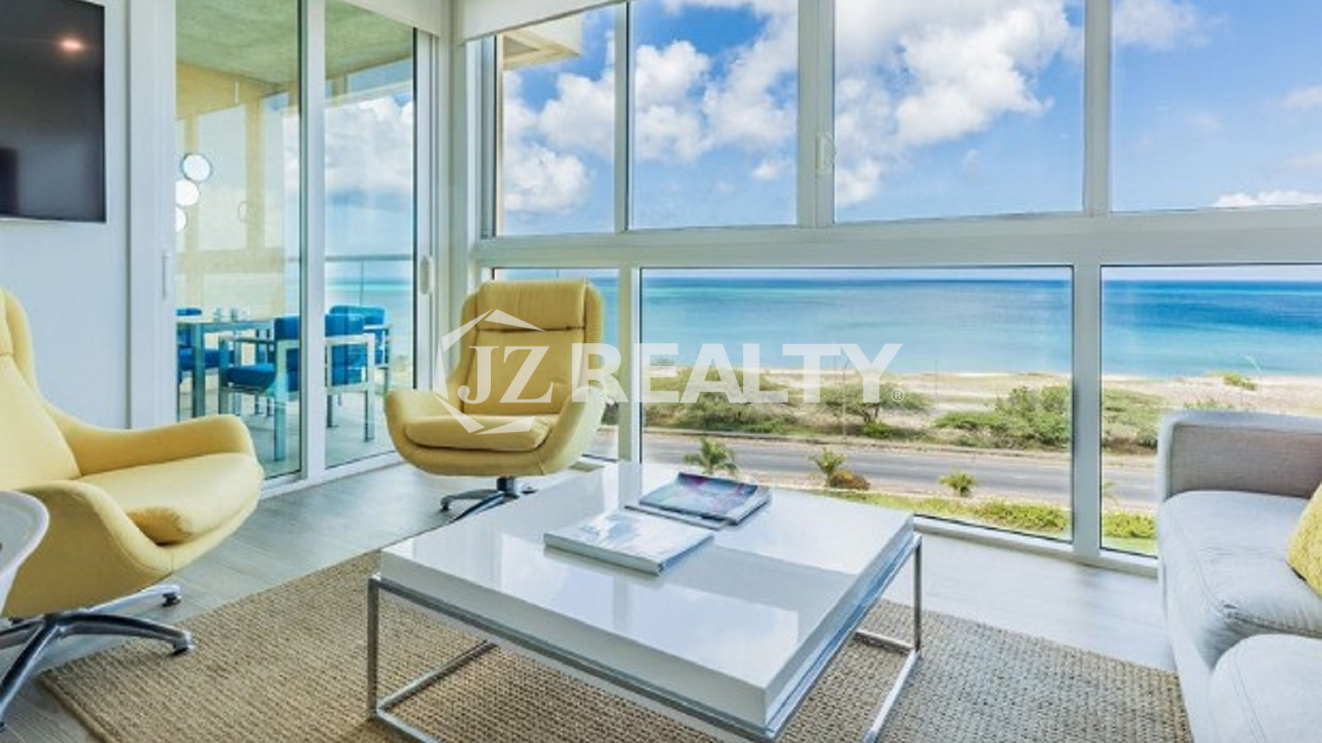 Condo 2-Bedroom Unit Blue Aruba living room with glass walls and ocean view
