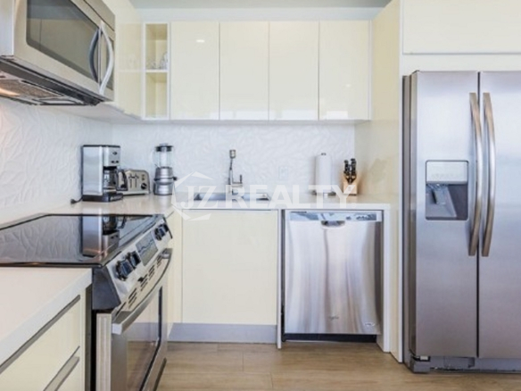 Condo 2-Bedroom Unit Blue Aruba modern kitchen with stainless steel appliances