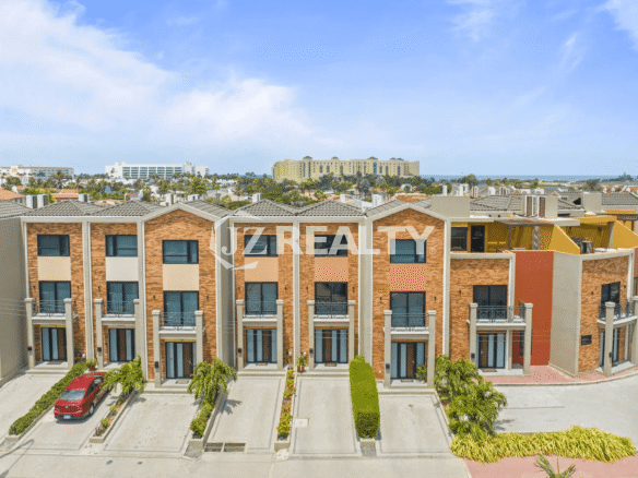 Aerial view of the modern, multi-story townhouses at Porta al Sole, showing the architectural style and private parking drives.