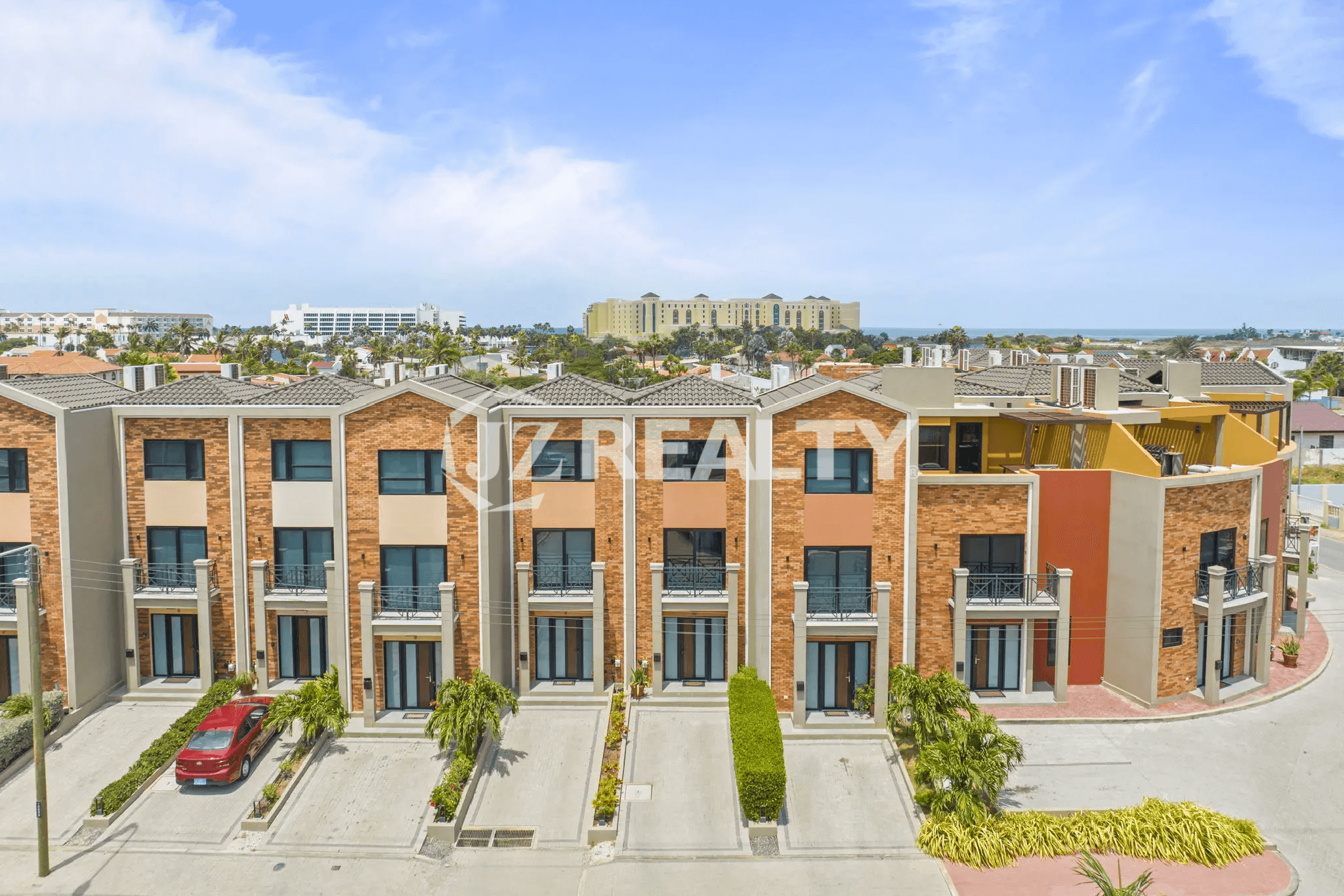 Aerial view of the modern, multi-story townhouses at Porta al Sole, showing the architectural style and private parking drives.