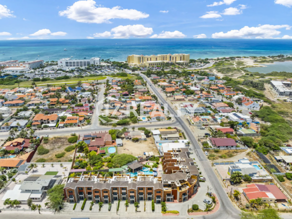 Porta al Sole Unit 11 wide aerial view of the community and surrounding neighborhood, showing the proximity to the ocean and major resort buildings.