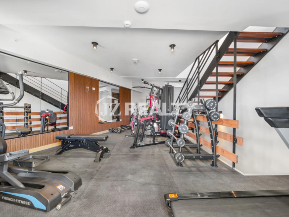Porta al Sole Unit 11 on-site fitness center with various exercise equipment including treadmills, weight racks, and a workout bench.