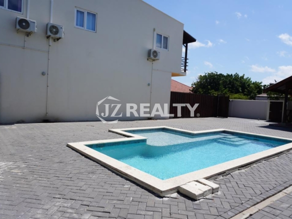 Swimming pool in paved courtyard of an Aruba apartment complex.