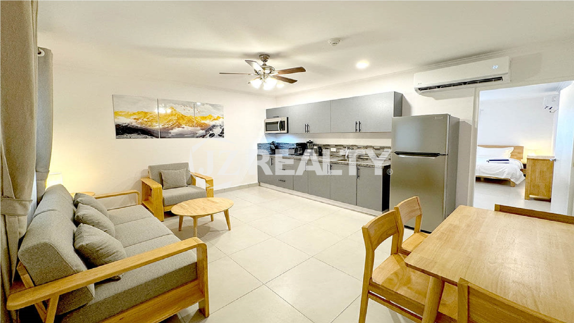 Wide view of the open-plan kitchen, living, and dining area.