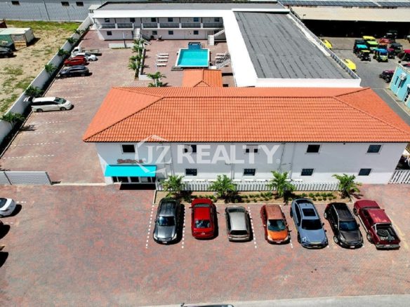 Aerial view of Bon Bini Suites, parking lot, and main building.