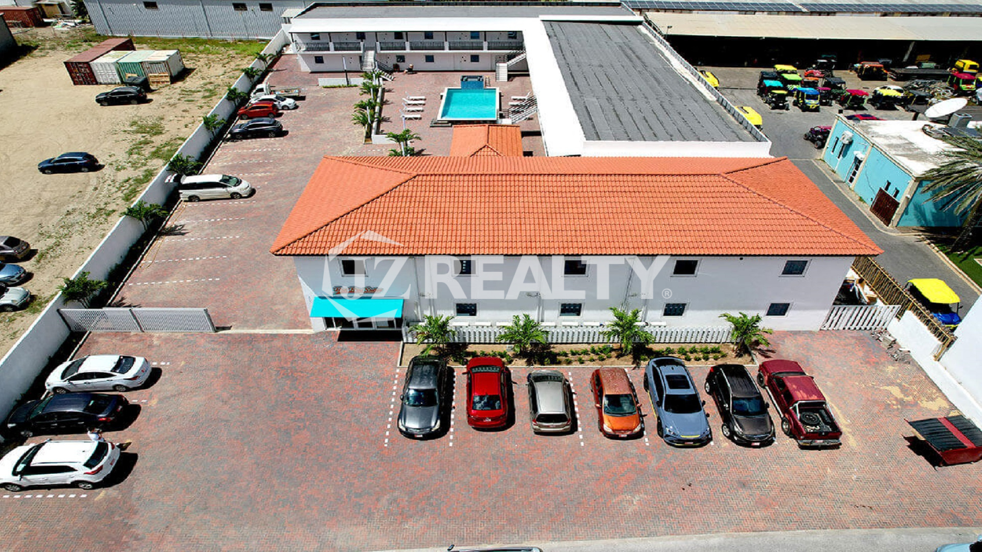 Aerial view of Bon Bini Suites, parking lot, and main building.