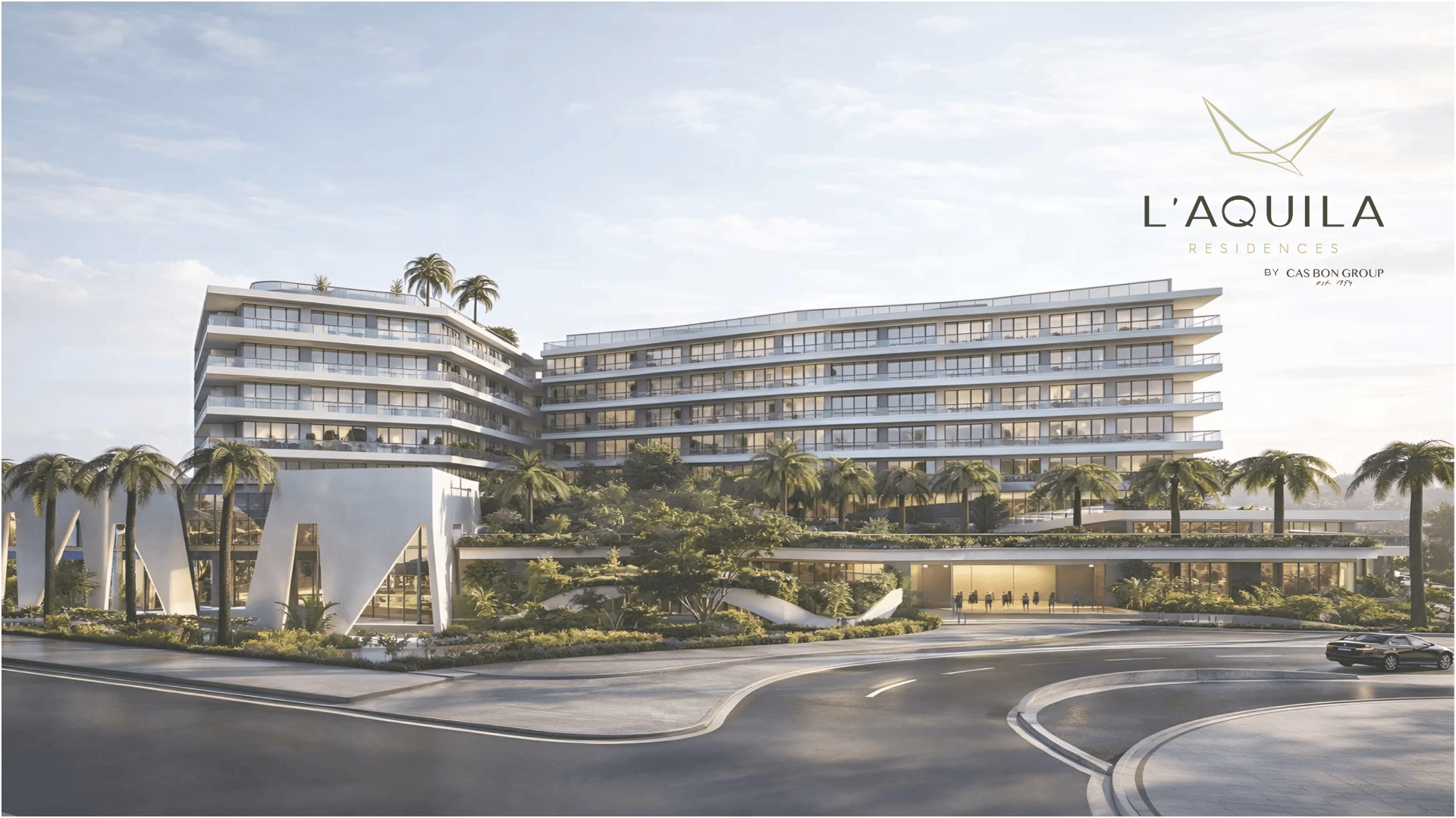 Exterior view of L’Aquila Residences condominium building in Aruba with modern architecture and landscaped entrance